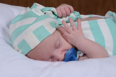 Close-up of baby sleeping on bed