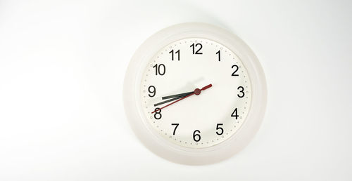 Close-up of clock on white background