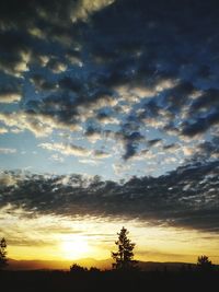 Silhouette of landscape against cloudy sky