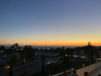 High angle view of illuminated buildings against sky during sunset