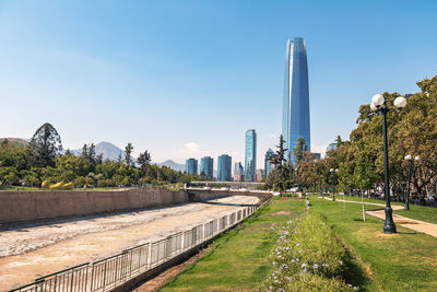 Buildings in city against clear sky