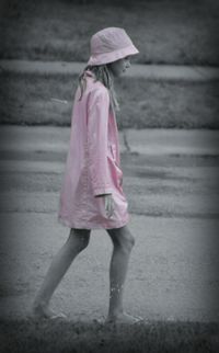 Rear view of a girl holding umbrella