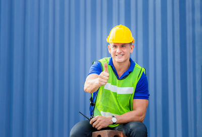 Man working against blue sky