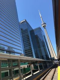 Low angle view of skyscrapers against clear blue sky