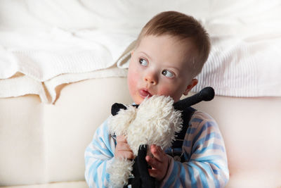 Close-up of cute physically impaired boy with toy