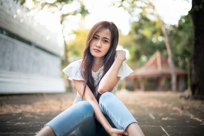 Portrait of young woman sitting outdoors