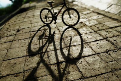 Shadow of bicycle on footpath