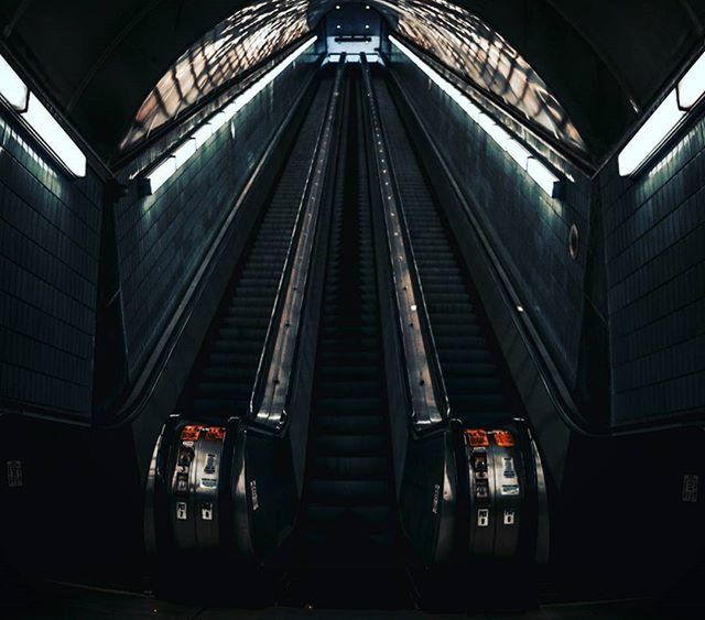 indoors, transportation, rail transportation, public transportation, railroad station, railroad track, illuminated, railroad station platform, train - vehicle, ceiling, subway station, subway, the way forward, architecture, escalator, built structure, mode of transport, interior, diminishing perspective, travel