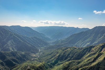 Misty mountain range covered with white mist and amazing blue sky