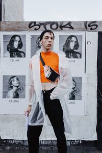 Full length of young man standing on wall