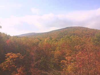 Scenic view of rainbow over mountain against sky