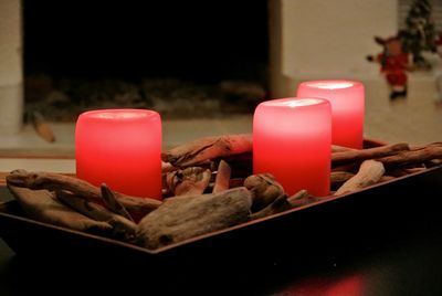 Close-up of illuminated candles on table