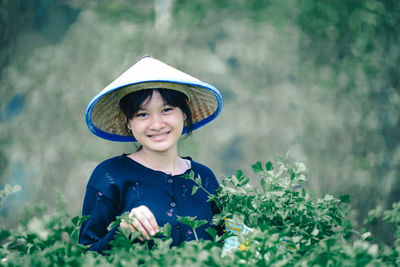 Portrait of cute girl standing against plants