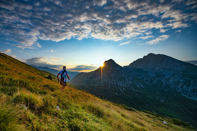 Man standing on mountain against sky