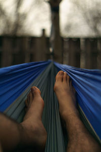 Low section of man resting on hammock