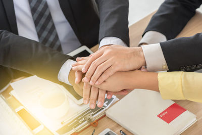 Business people with stacked hands over table