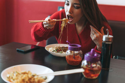 Midsection of woman eating food