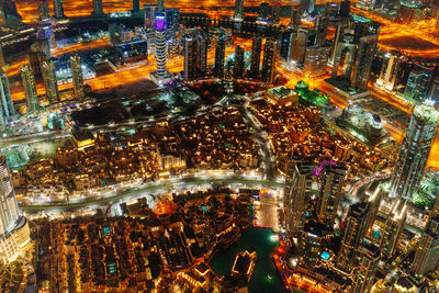 High angle view of city lit up at night