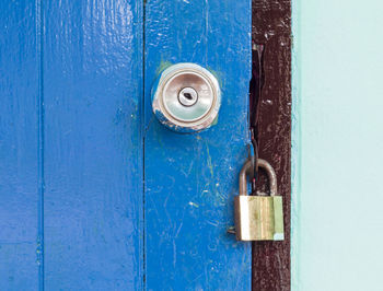 Close-up of padlock on blue door