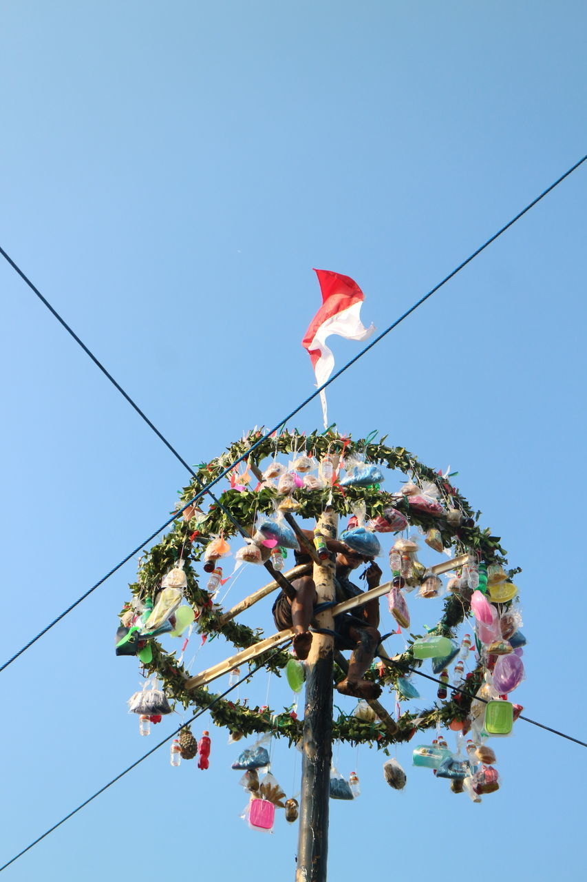 LOW ANGLE VIEW OF PINK FLAG AGAINST SKY