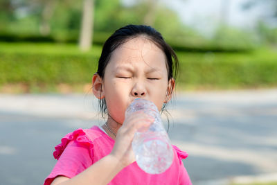 Cute girl drinking water