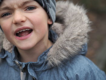 Close-up portrait of angry boy during winter