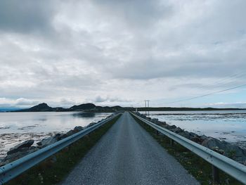 Road by bridge against sky