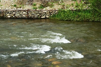 High angle view of river flowing through rocks