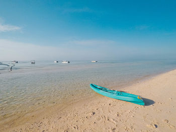 Scenic view of beach against blue sky