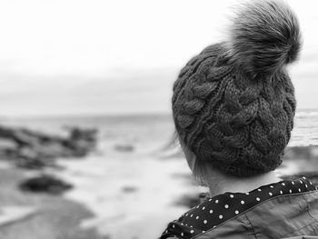 Woman wearing a knit hat at the beach