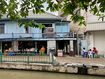 People outside house against building