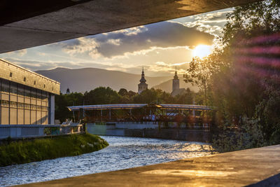 Bridge over river against sky at night