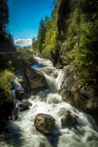 Stream flowing through rocks in forest