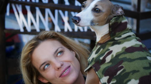 Close-up of young woman with dog