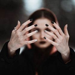 Close-up of woman showing nail polish