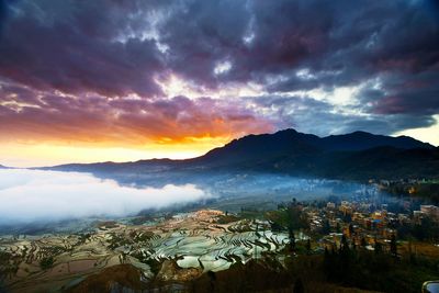 Scenic view of mountains against sky at sunset