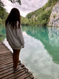 Rear view of woman looking at lake