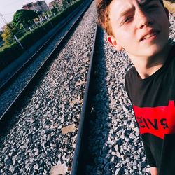 High angle view of man looking at railroad track