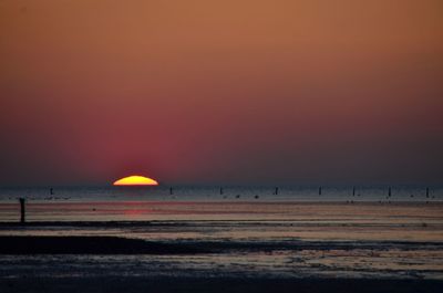 Scenic view of beach against sky during sunset