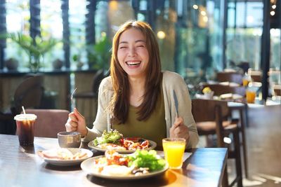 Portrait of young woman sitting at restaurant