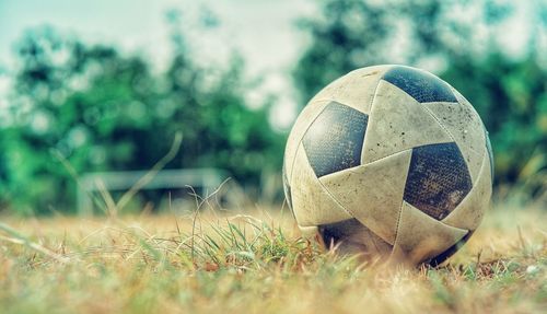 Close-up of soccer ball on grassy field