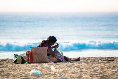 Mother with child on shore at beach