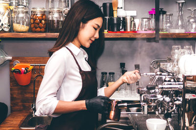 Midsection of woman standing at cafe