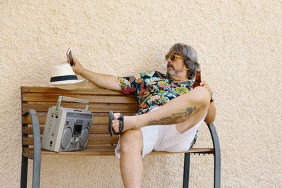 Midsection of woman sitting on chair