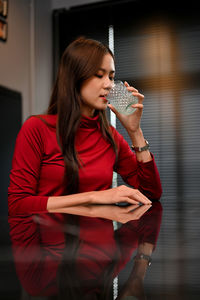 Young woman drinking glass