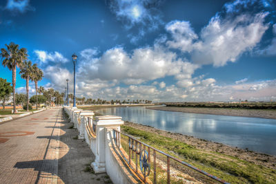 Road by river against sky