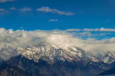 Scenic view of snowcapped mountains against sky