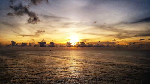 Scenic view of sea against romantic sky at sunset