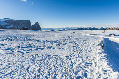 Scenic view of snowcapped mountains against blue sky