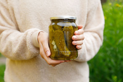 Midsection of woman holding drink